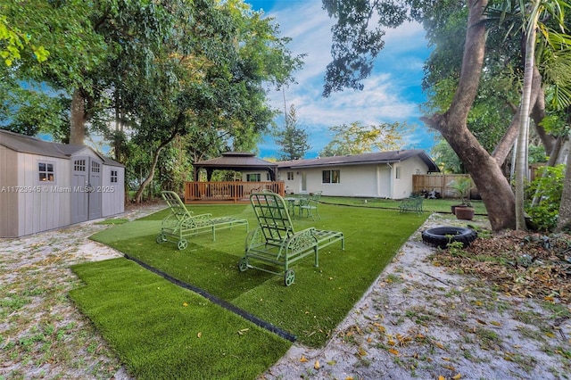 view of yard with a gazebo, a fire pit, and a shed