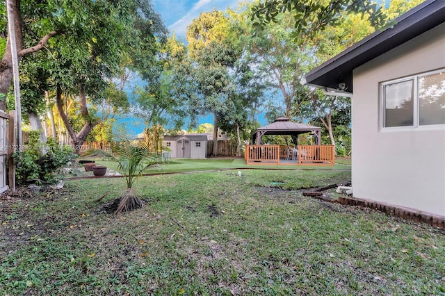 view of yard featuring a gazebo and a storage shed