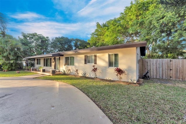 ranch-style home featuring a front yard