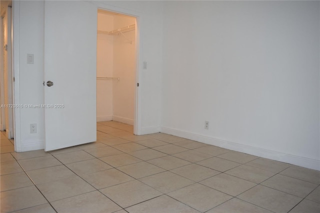 unfurnished room with light tile patterned flooring