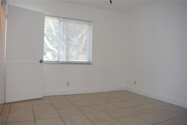 spare room featuring light tile patterned floors