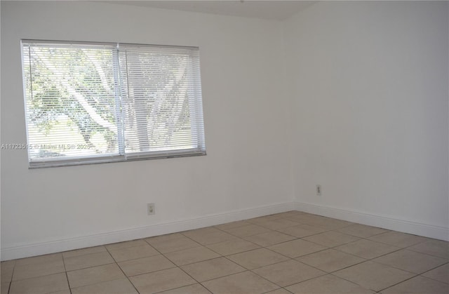 tiled empty room with a healthy amount of sunlight