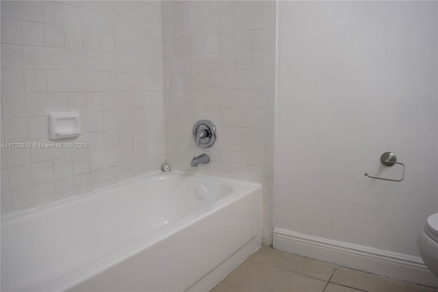 bathroom with tile patterned floors, toilet, and tub / shower combination