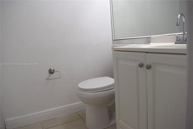 bathroom with tile patterned floors, vanity, and toilet