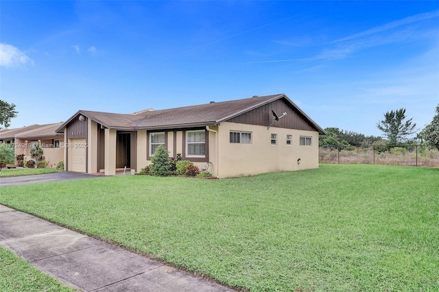 view of front of house featuring a front yard and a garage