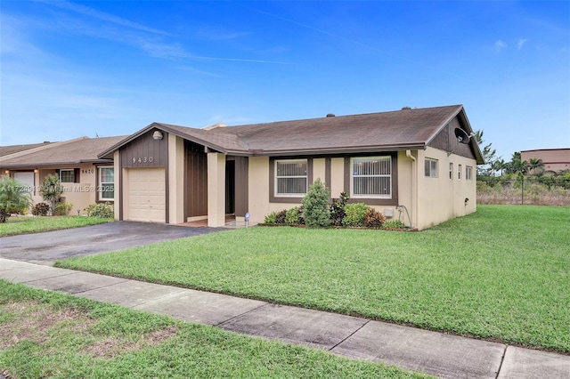 ranch-style house featuring a front yard and a garage