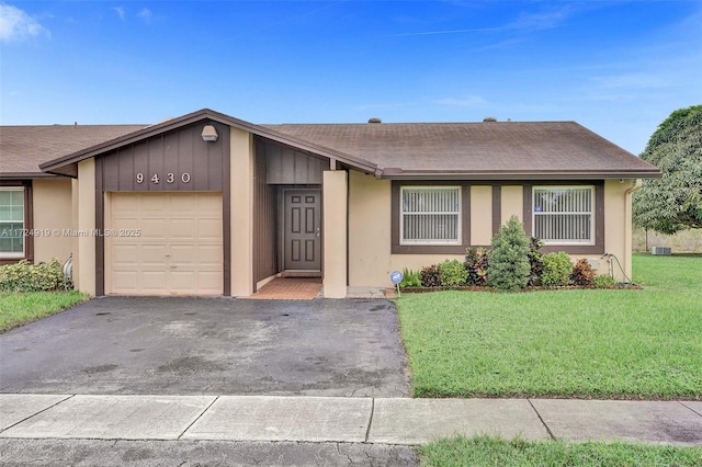 ranch-style house with a front yard and a garage