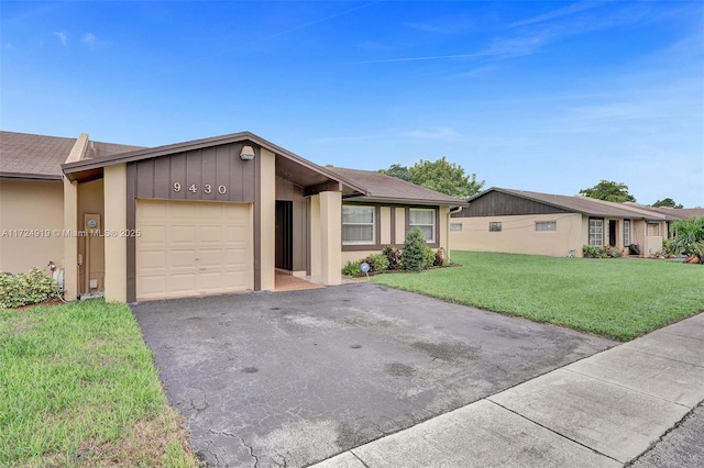 ranch-style house featuring a front lawn and a garage