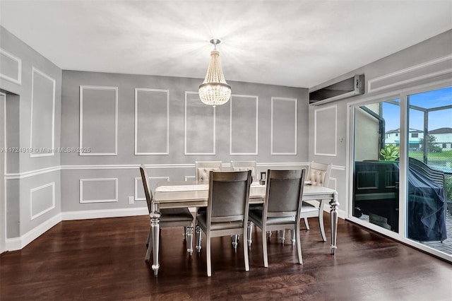 dining space featuring a chandelier and dark wood-type flooring