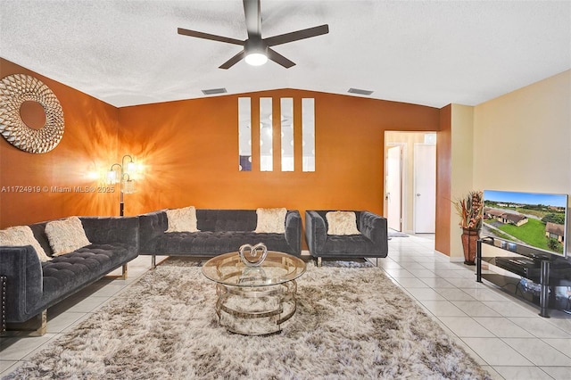 living room featuring a textured ceiling, ceiling fan, lofted ceiling, and light tile patterned flooring