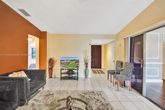 living room with light tile patterned floors and lofted ceiling