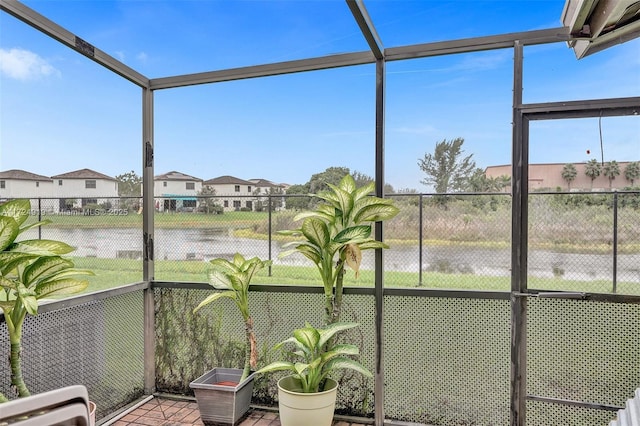 unfurnished sunroom featuring a water view