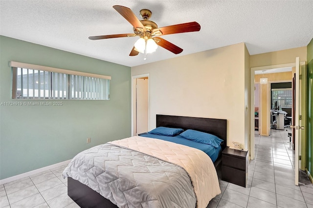 tiled bedroom featuring a textured ceiling and ceiling fan