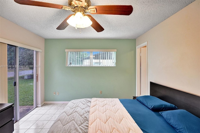 unfurnished bedroom featuring ceiling fan, access to exterior, light tile patterned floors, and a textured ceiling