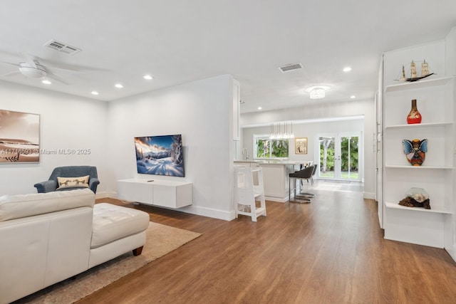 living area featuring wood finished floors, visible vents, and recessed lighting