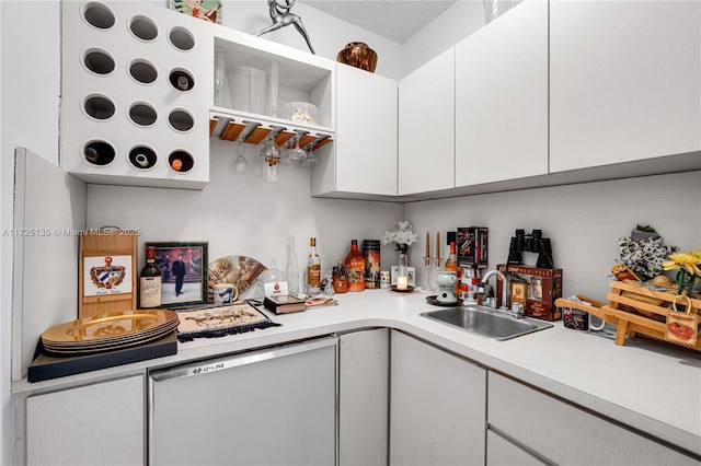 kitchen featuring sink and white cabinetry