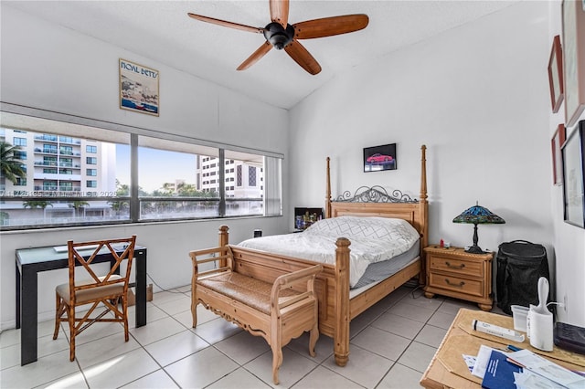 tiled bedroom featuring lofted ceiling and ceiling fan