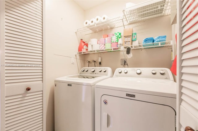 clothes washing area with laundry area and washer and clothes dryer