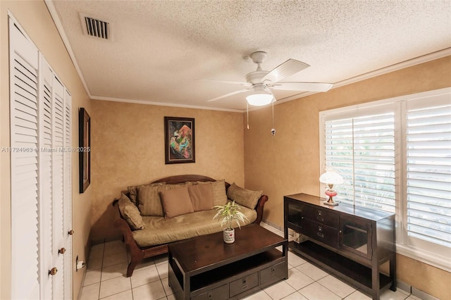 living room with visible vents, a textured ceiling, crown molding, and a ceiling fan