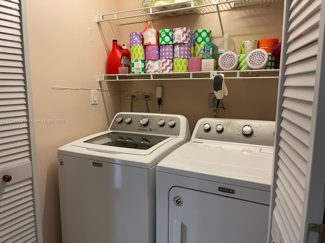 clothes washing area with washing machine and dryer