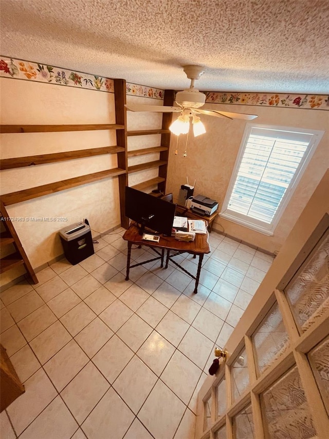 unfurnished dining area featuring tile patterned flooring, a textured ceiling, and ceiling fan