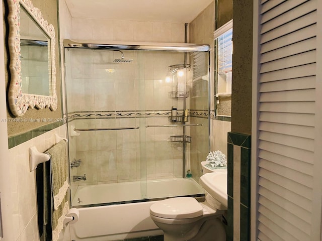 bathroom with toilet and enclosed tub / shower combo