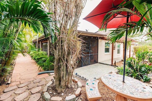 view of patio / terrace featuring a sunroom