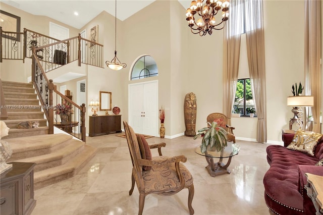 interior space featuring a high ceiling, plenty of natural light, and an inviting chandelier