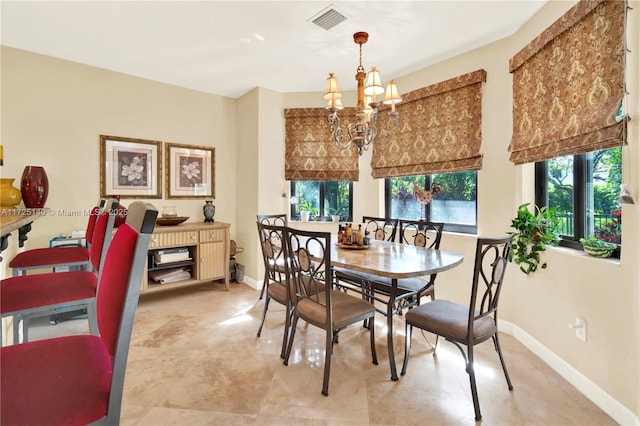 dining space featuring plenty of natural light and an inviting chandelier