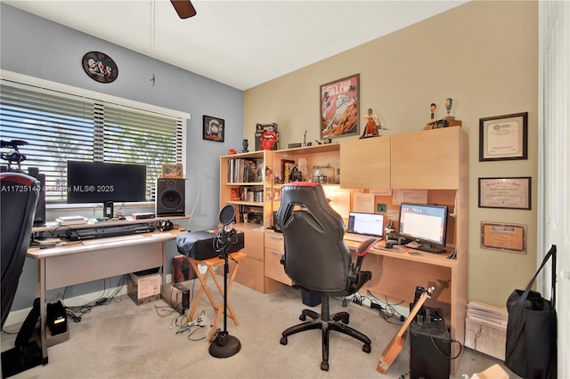 carpeted office space featuring ceiling fan