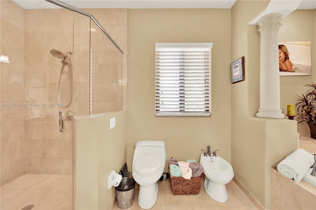 bathroom with decorative columns, a bidet, toilet, and a shower with shower door