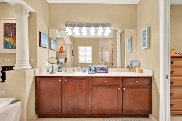 bathroom with vanity, plus walk in shower, and decorative columns