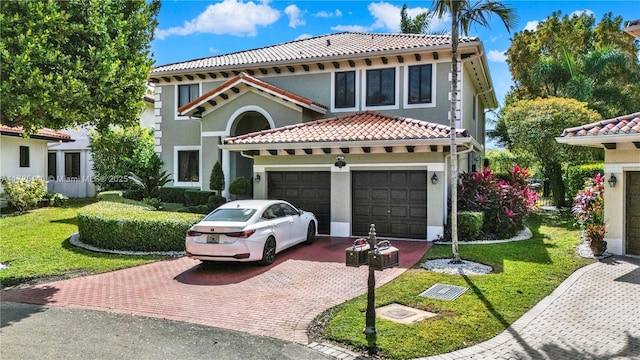 mediterranean / spanish house featuring a garage and a front lawn