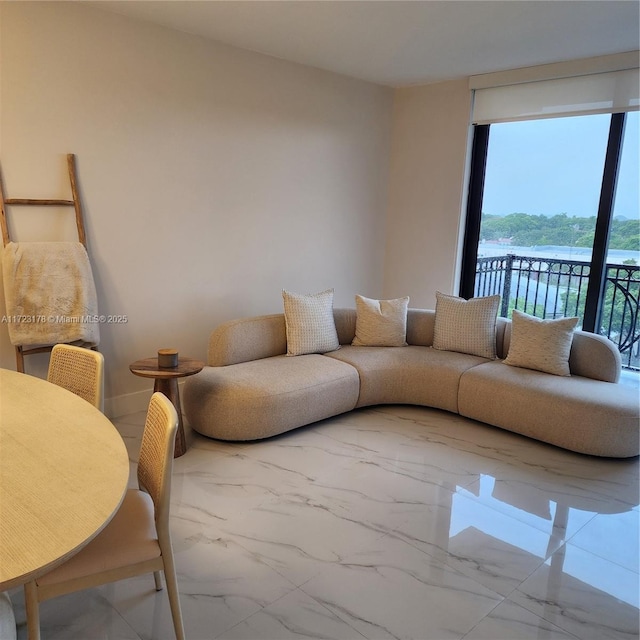 living room with a water view and plenty of natural light