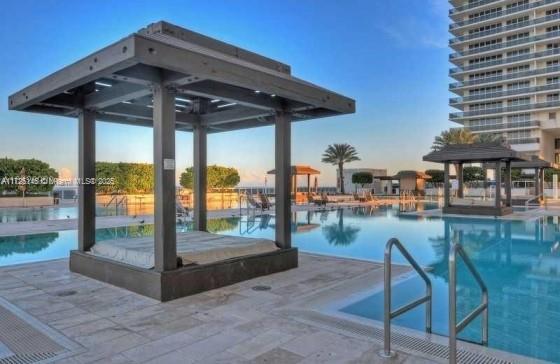 view of pool featuring a gazebo and a patio area