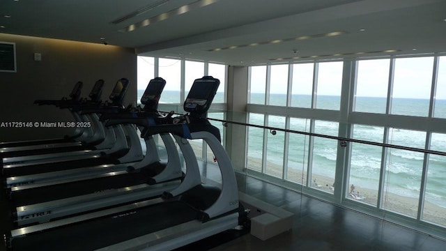 workout area featuring a water view