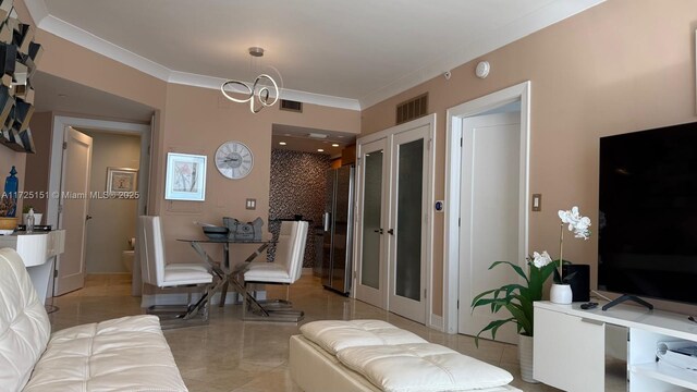 living room with ornamental molding and a notable chandelier