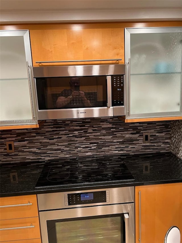 kitchen featuring appliances with stainless steel finishes and decorative backsplash