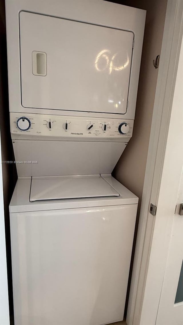 washroom featuring laundry area and stacked washer / drying machine