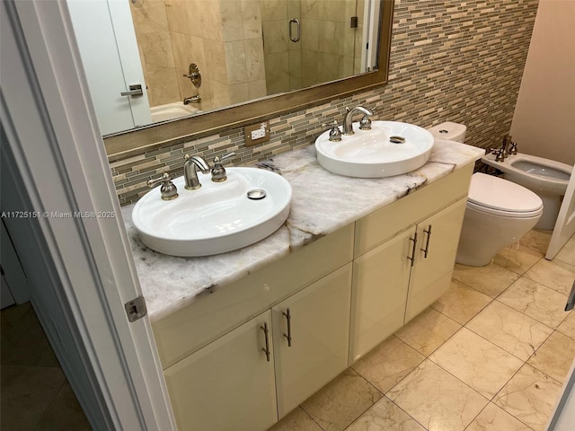 bathroom featuring a bidet, toilet, decorative backsplash, a shower, and vanity