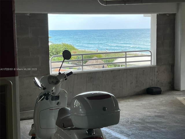 balcony featuring a water view and a view of the beach