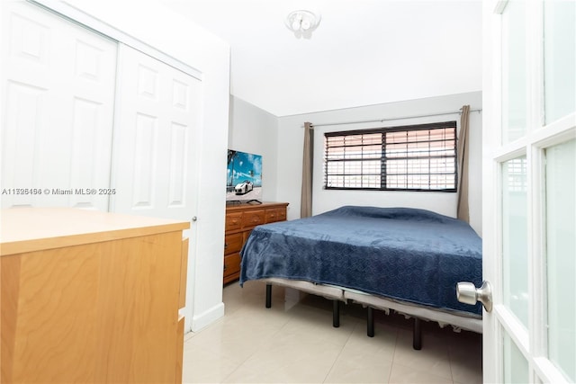 bedroom with light tile patterned floors