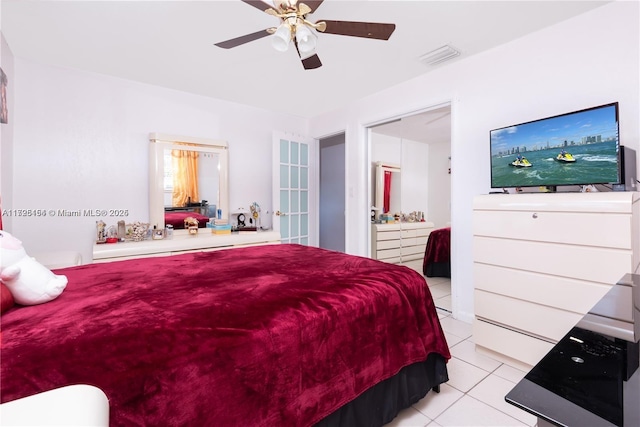 tiled bedroom featuring ceiling fan