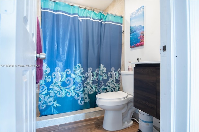 bathroom with toilet, wood-type flooring, vanity, and a shower with shower curtain