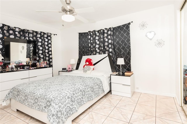 bedroom with ceiling fan and light tile patterned floors