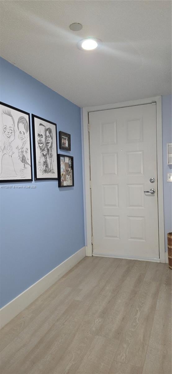 unfurnished bedroom featuring a closet and light hardwood / wood-style flooring