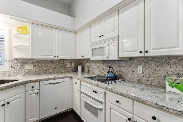 kitchen featuring white appliances and white cabinets