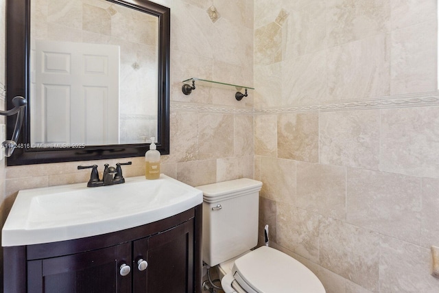 bathroom with tile walls, vanity, decorative backsplash, and toilet