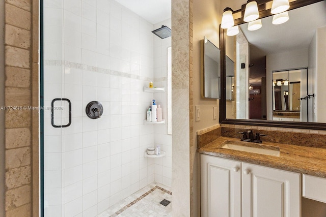 bathroom with a shower with door and vanity