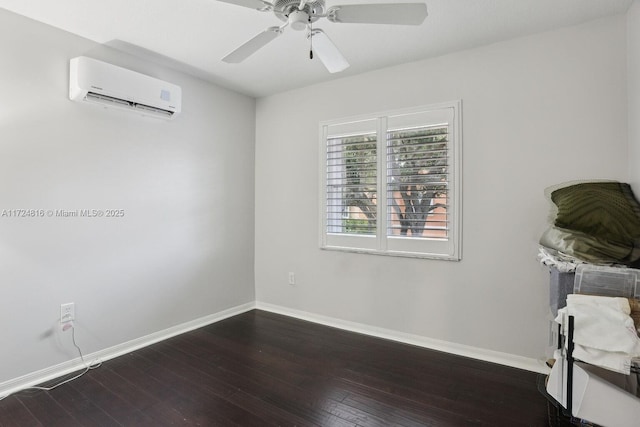 empty room with a wall unit AC, dark hardwood / wood-style flooring, and ceiling fan